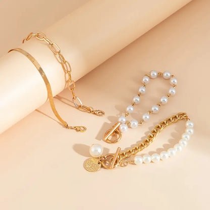 Chic 4-Piece Gold Bracelet Set – Snake, Pearls, and Links